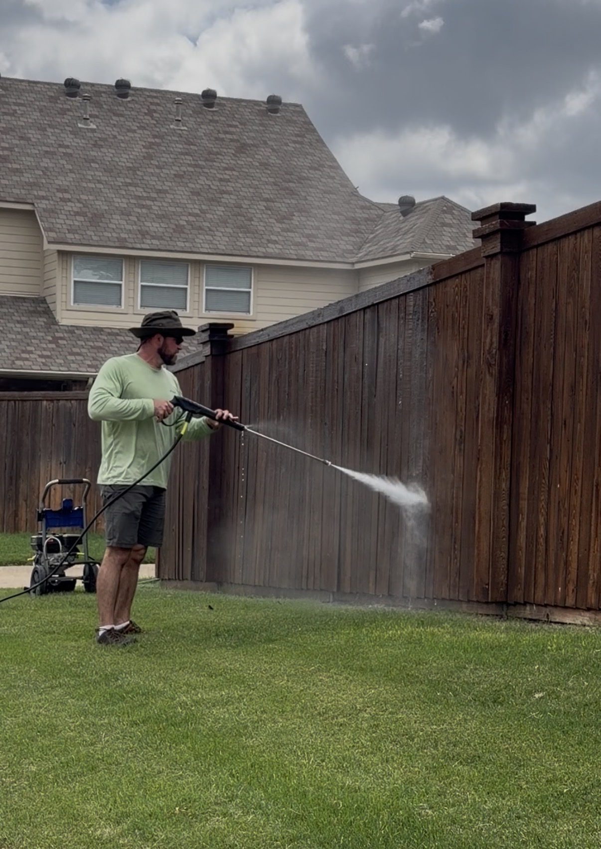 Pressure washing a backyard fence
