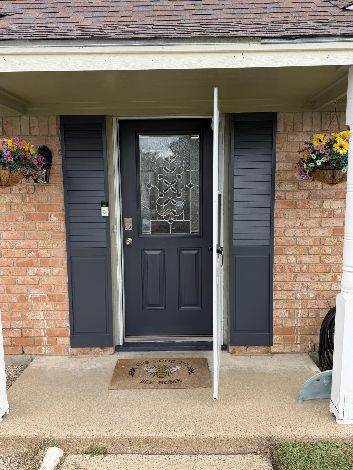 Front entry with freshly painted charcoal door